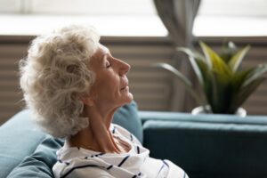 senior-woman-leaning-back-with-eyes-closed