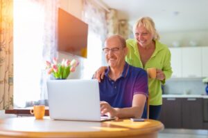 senior-couple-looking-at-laptop